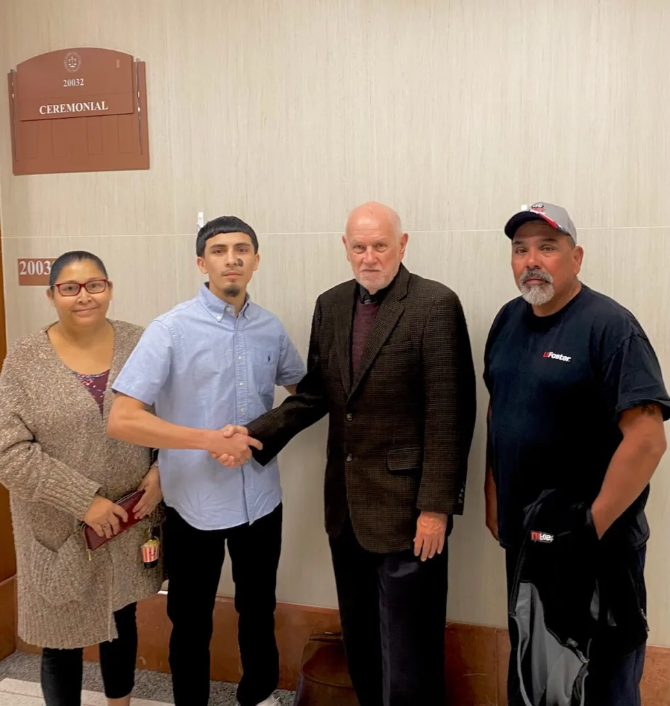 Christopher Santos with his mother and father at the Court House